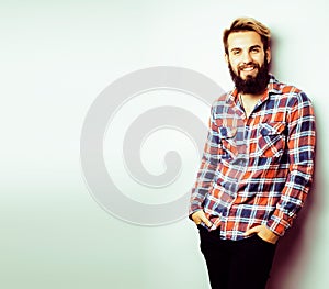 Portrait of young bearded hipster guy smiling on white background