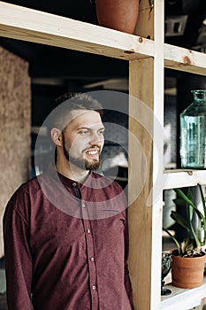 Portrait of a young bearded man in front of door