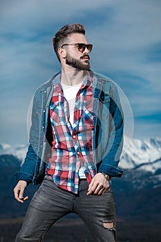 Portrait of a young bearded man looking to side