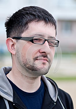 Portrait of a young bearded man wearing glasses