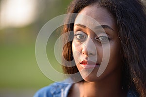 Portrait of young beautiful African woman at the park outdoors