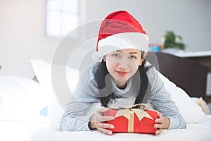 Portrait of young beautiful asian woman with christmas present .