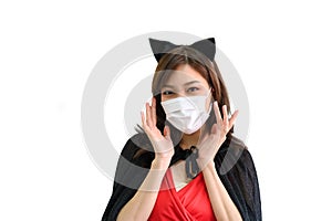 Portrait of young beautiful asian woman with protection face mask against coronavirus wearing red dress and black shawl on white