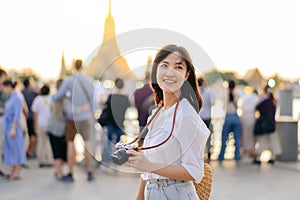 Portrait young beautiful asian woman smiling while travel at Wat Arun sunset view point, Bangkok, Thailand