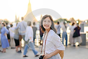 Portrait young beautiful asian woman smiling while travel at Wat Arun sunset view point, Bangkok, Thailand