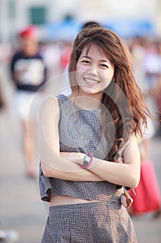 portrait of young beautiful asian woman standing and toothy smiling to camera with happiness emotion