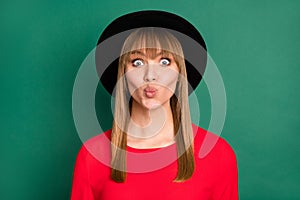 Portrait of young beautiful attractive pretty charming girl in big black hat pout lips isolated on green color