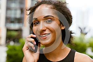 Portrait of young beautiful attractive smiling woman talking phone