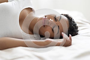 Portrait Of Young Beautiful Black Woman Sleeping In Comfortable Bed At Home