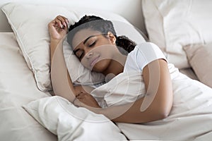 Portrait Of Young Beautiful Black Woman Sleeping In Comfortable Bed At Home