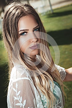 Portrait of a young and beautiful blonde woman, blue eyes, long hair.