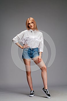 Portrait of a young beautiful blonde woman in a white shirt