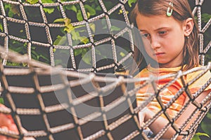 Portrait of young beautiful business girl lies in a hammock and working remotely with laptop. Horizontal image