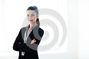 Portrait of young beautiful business woman with crossed arms