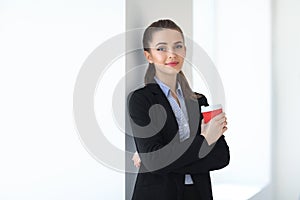 Portrait of young beautiful business woman with cup of coffee in