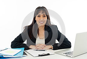 Portrait of a young beautiful business woman happy and confident working on computer at office