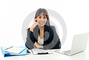 Portrait of a young beautiful business woman happy and confident working on computer at office