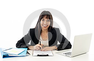 Portrait of a young beautiful business woman happy and confident working on computer at office