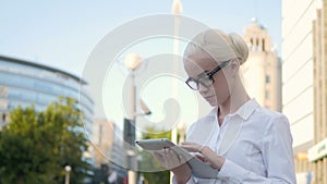 Portrait of Young Beautiful Business Woman Using Tablet PC Outdoors