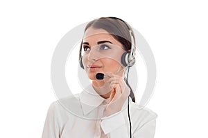 Portrait of young beautiful call center worker girl with headphones and microphone posing isolated on white background