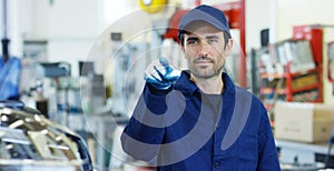 Portrait of a young beautiful car mechanic in a car workshop, in the background of a car service Concept repair of machines, fault