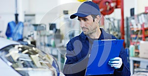 Portrait of a young beautiful car mechanic in a car workshop, in the background of service. Concept: repair of machines, fault dia