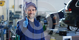 Portrait of a young beautiful car mechanic in a car workshop, in the background of service. Concept: repair of machines, fault dia