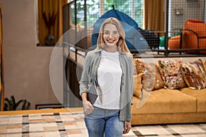 Portrait of a young beautiful caucasian businesswoman or female office worker looking at camera and smiling while