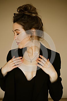 portrait of young beautiful caucasian woman in a black jacket , slender beautiful lady with hairstyle and makeup in a