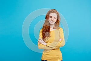 Portrait of young beautiful ginger woman with freckles cheerfuly smiling looking at camera. Isolated on pastel blue