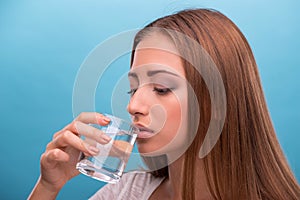 Portrait of young beautiful girl drinking clean