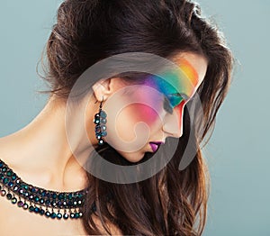 Portrait of a young beautiful girl with a fashion bright multicolored makeup