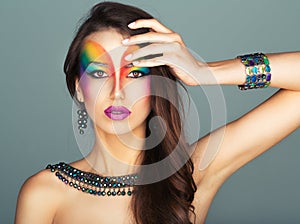 Portrait of a young beautiful girl with a fashion bright multicolored makeup