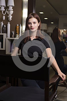 Portrait of a young beautiful girl, with flawless skin, in a beauty salon. Makeup master at the workplace
