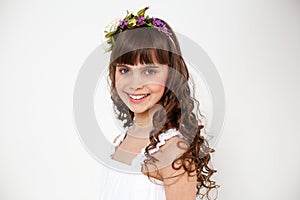 Portrait of a young beautiful girl in a flower wreath