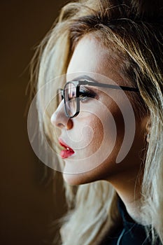 Portrait of a young beautiful girl in glasses with diopters.