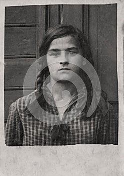 Portrait of a young beautiful girl with pigtails. Vintage photo circa 1925. USSR, Rostov