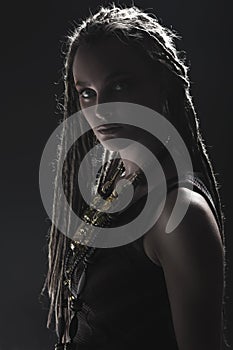 Portrait of young beautiful girl with stylish make-up and dreads