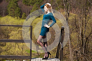 Portrait of a young beautiful girl in turquoise dress