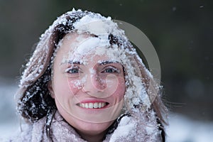 Portrait of a young beautiful girl in winter outdoors in a park