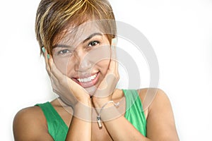 Portrait of young beautiful and happy Asian Singaporean or Malay woman smiling joyful with hands on her face isolated on white