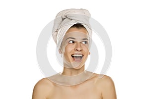 Portrait of young beautiful happy woman with towel on her head