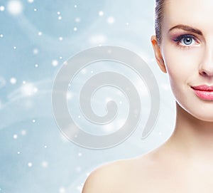 Portrait of young, beautiful and healthy woman: over winter background. Healthcare, spa, makeup and face lifting concept