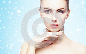 Portrait of young, beautiful and healthy woman: over winter background. Healthcare, spa, makeup and face lifting concept