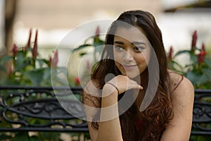 Portrait of young beautiful Indian woman at the park