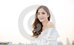 Portrait of young beautiful innocence asian woman in sky roof top.