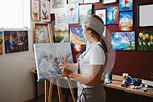 Caucasian woman artist drawing painting in art studio