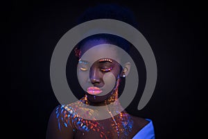 Portrait of young beautiful model girl with fluorescent makeup isolated