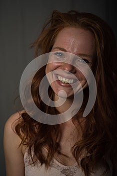 Portrait of a young, beautiful, red-haired woman who laughs