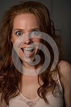 Portrait of a young, beautiful, red-haired woman who laughs